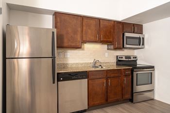 Modern kitchen with a granite countertop and stainless steel appliances